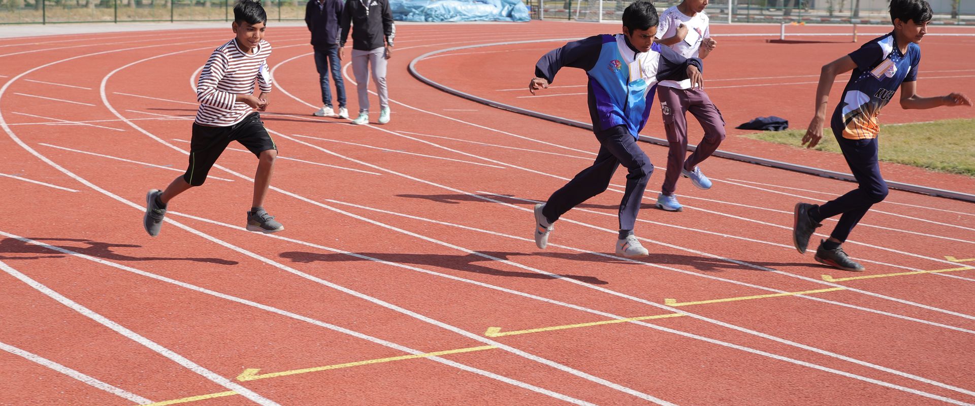 Athletes sprinting in a race at the Special Khel Mahakumbh 2025 state-level competition, Porbandar