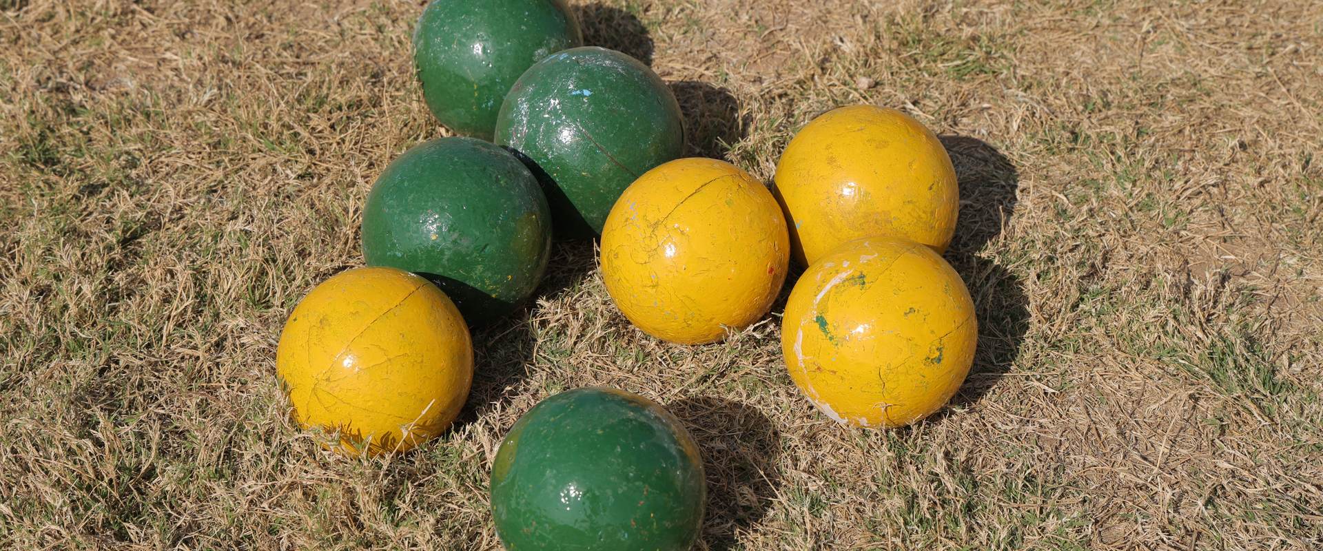Green and yellow boccia balls on the grass at the Special Khel Mahakumbh 2025 state-level competition, Porbandar